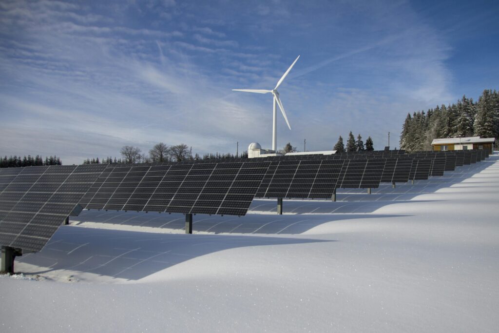 Solar panels covered in light snow, showing how winter weather affects energy production