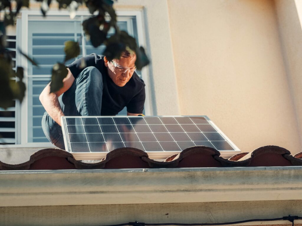 Technician installing or inspecting solar battery system